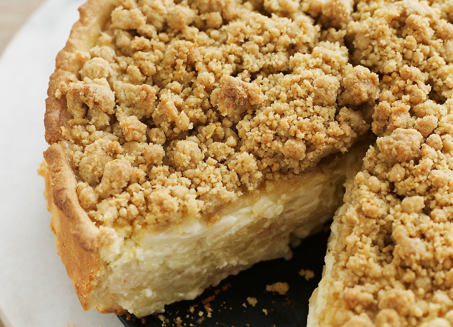 Decorative Amish Vanilla Pie with a slice cut out of it.