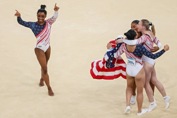 Simone Biles, Sunisa Lee, Jade Carey and Jordan Chiles of the US celebrate after winning the gold medal during the Artistic Gymnastics...